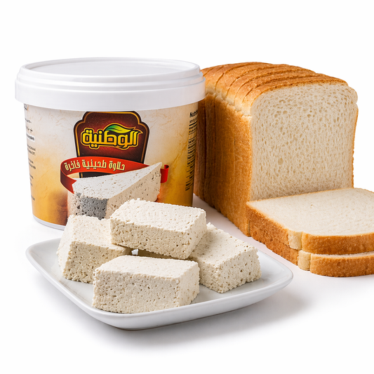 Container of a white spreadable food product with slices of bread on a white background
